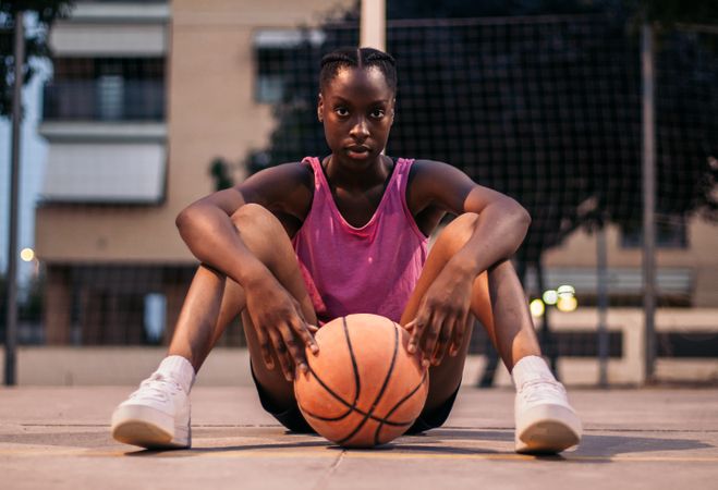 Confident female basketball player on the court