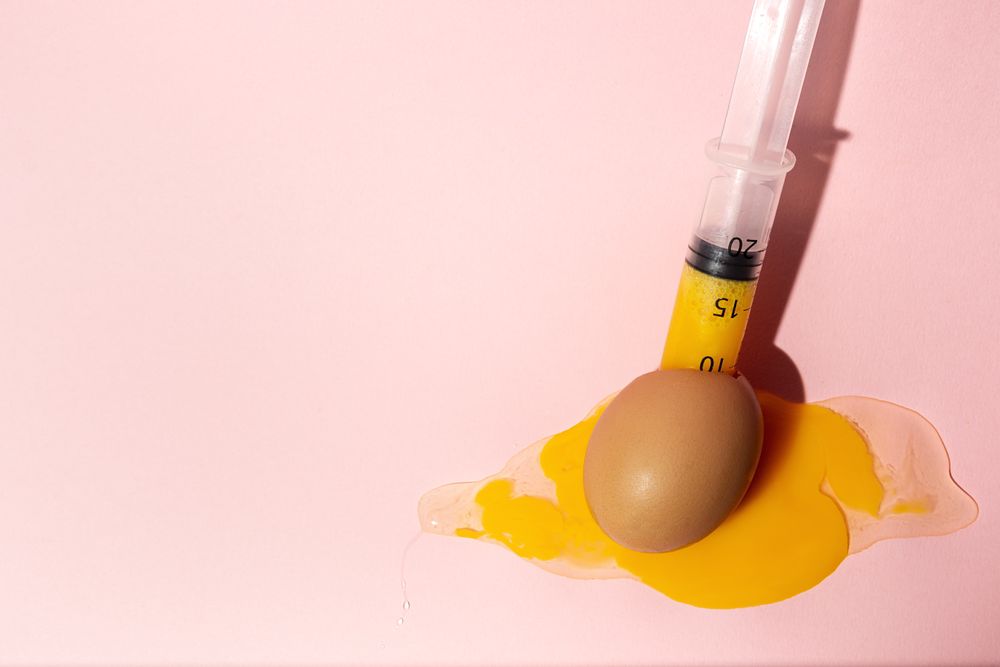 Syringe sucking yolk out of raw egg
