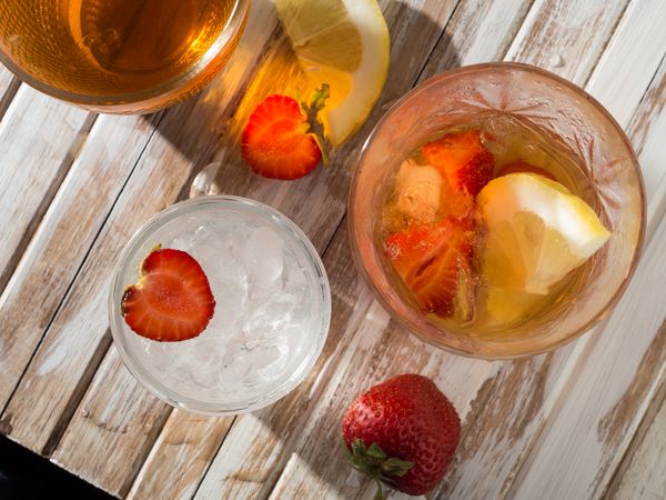 Glass of refreshing strawberry drink in daylight