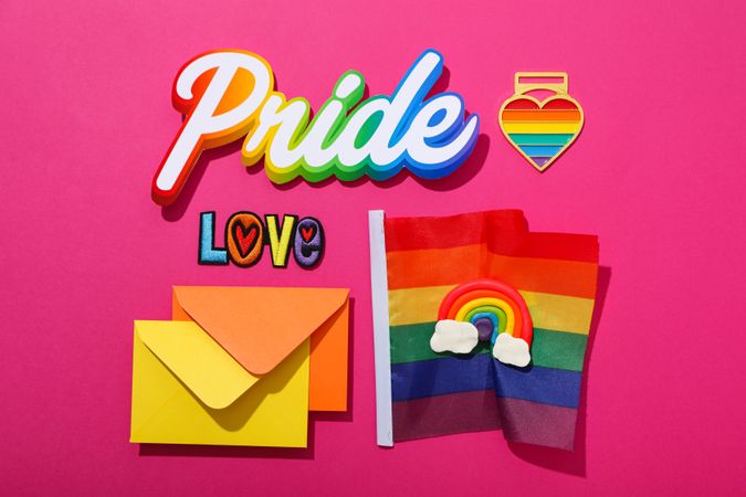 Pride parade concept, holiday symbols on pink background.