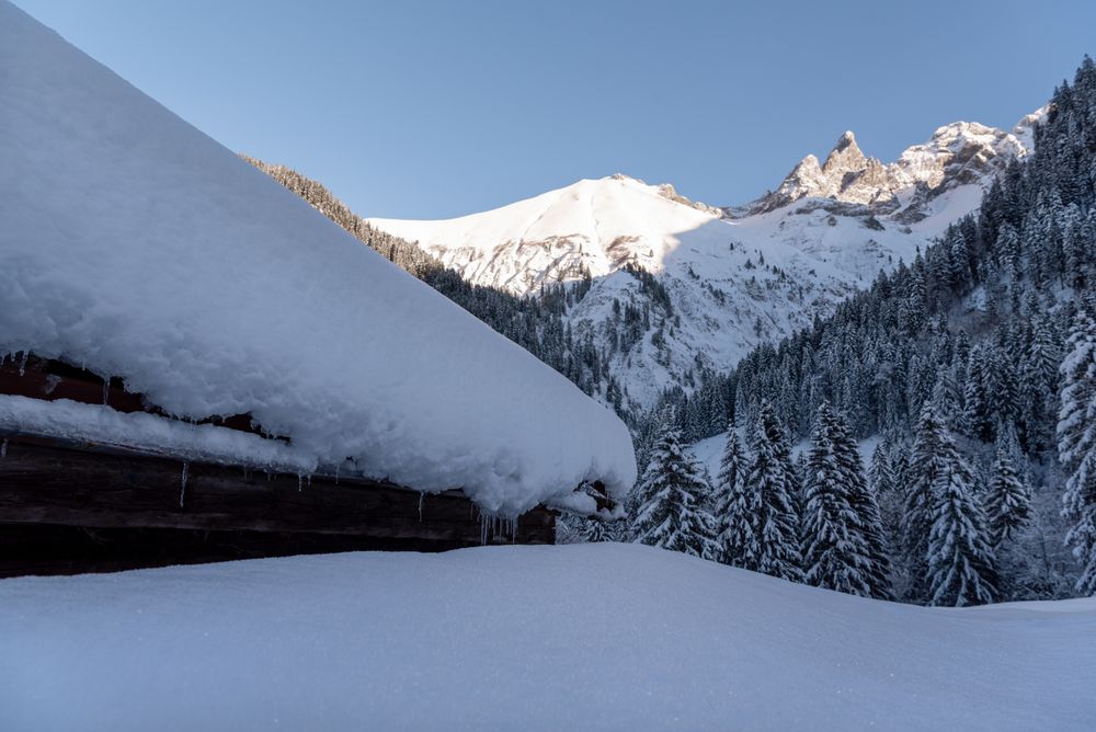 Snow-covered rustic mountain cabin in the Bavarian Alps, in Germany
