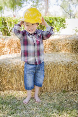 Biracial Boy Laughing with Hard Hat Outside