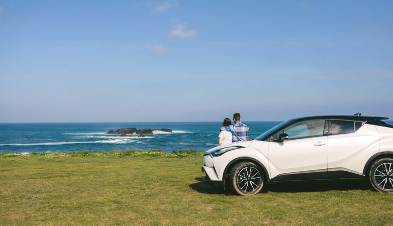 Couple with car watching landscape