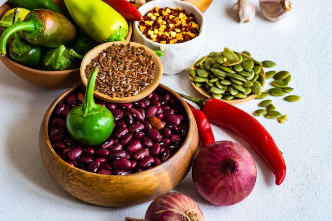 Bowls of kidney beans, seeds and aromatics