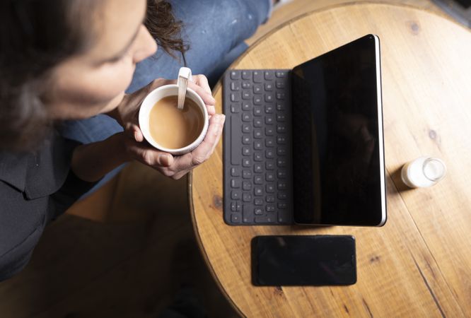 Young female using digital tablet in cafe