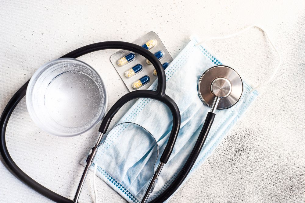 Top view of pills, facemask and stethoscope