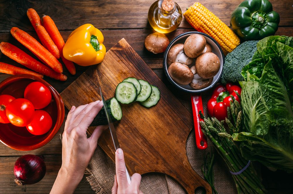 Vegetables and utensils on kitchen table