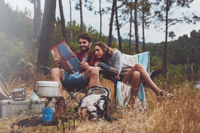 Adventurous young couple camping outdoors in nature