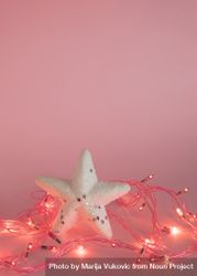 Star surrounded by fairy lights on pink background bDB2p5