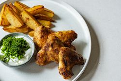 chicken wings with dip and potato wedges top view