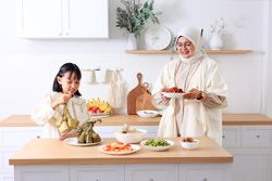 Mom and Daughter Preparing Ketupat Lebaran for Eid Al Fitr Celebration at Home