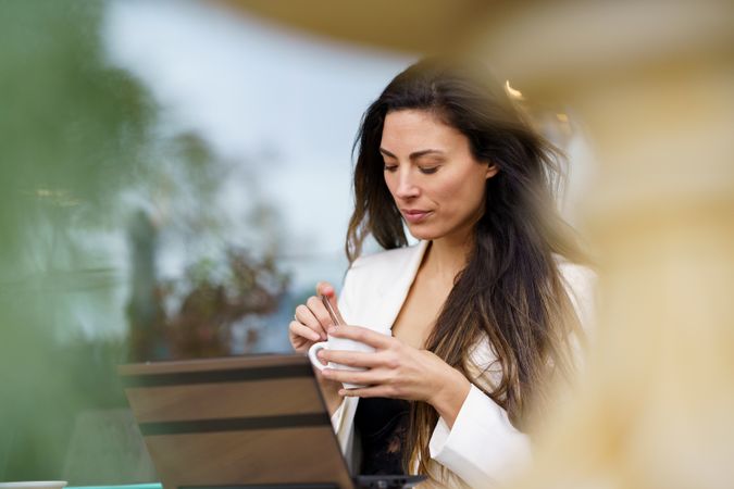 Focused Woman Enjoying Coffee in a Modern Caf Setting