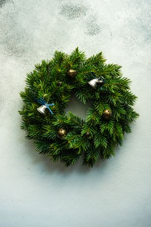 Christmas wreath with brass bells on marble counter