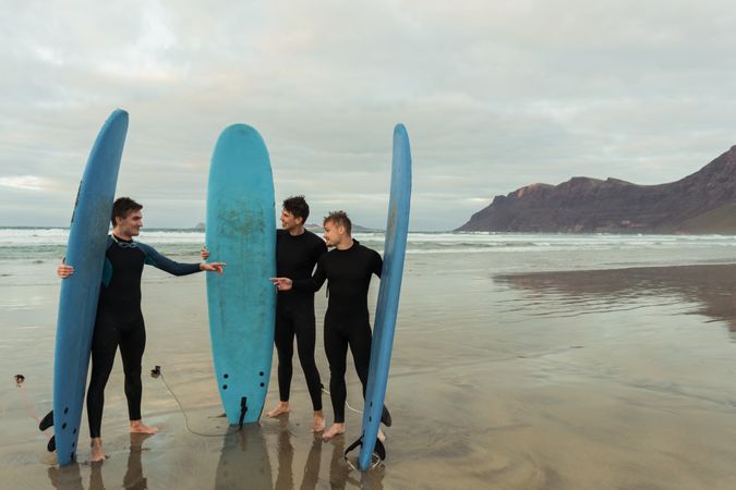 Excited men with surfboards