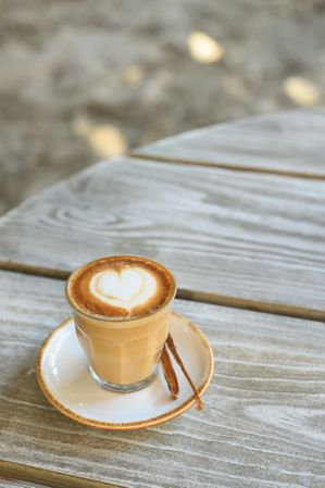 Glass of delicious latte with heart shaped froth