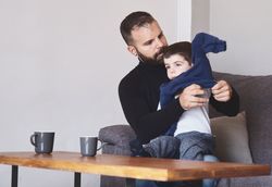 Bearded father dressing son