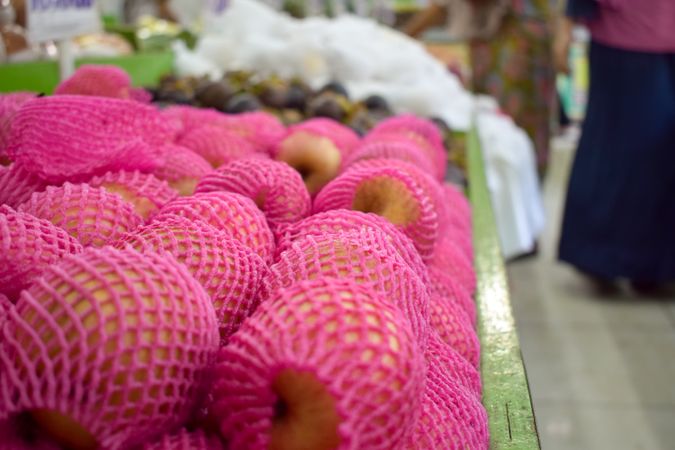 Pear fruit pack wrapped in pink and for sale in grocery store