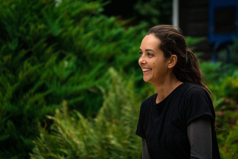 Cheerful woman resting in garden during training
