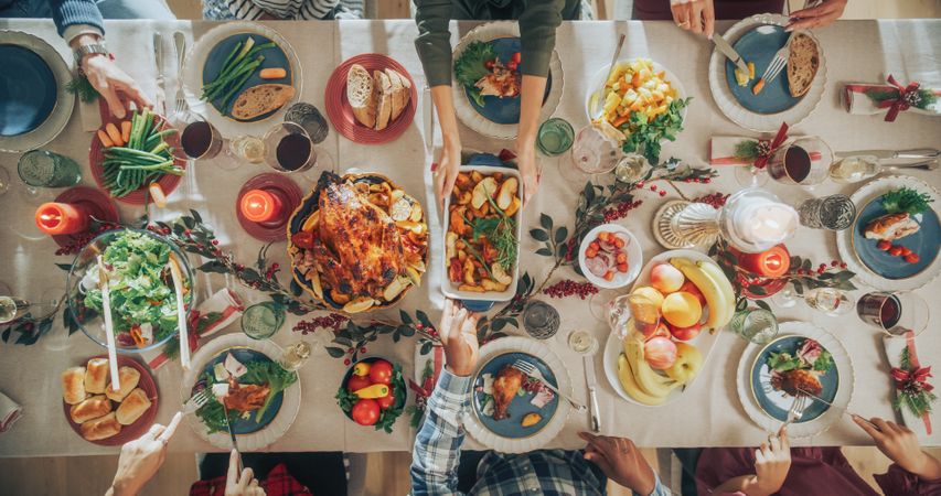 Top Down View with Anonymous Family, Children, Friends Gathered at Home for a Festive Christmas Dinner.