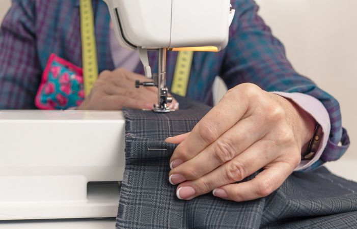 Seamstress hands working on a sewing machine