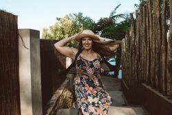 Cheerful woman in summer dress spinning around