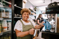 Portrait of older Black woman working as barista in cafe bDeMQ0