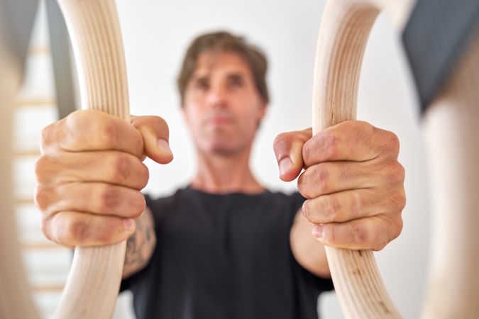 Sportsman during suspension training in gym