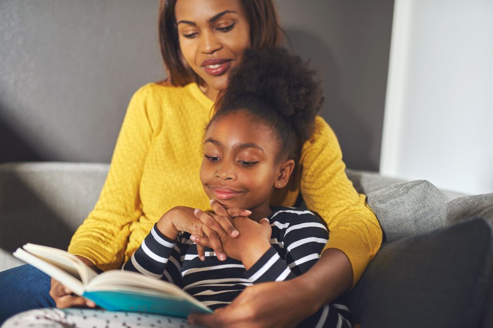 Mother reads her daughter a story