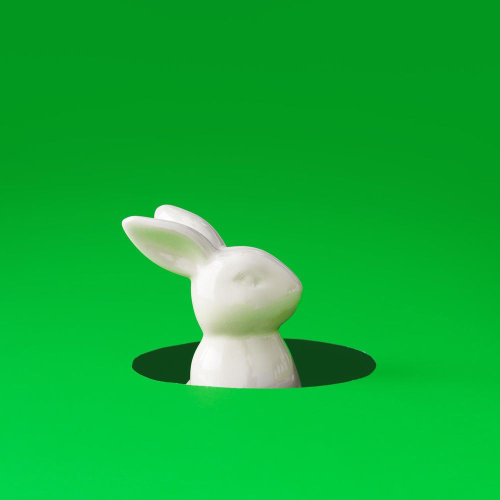 Easter bunny rabbit peeking out from hole