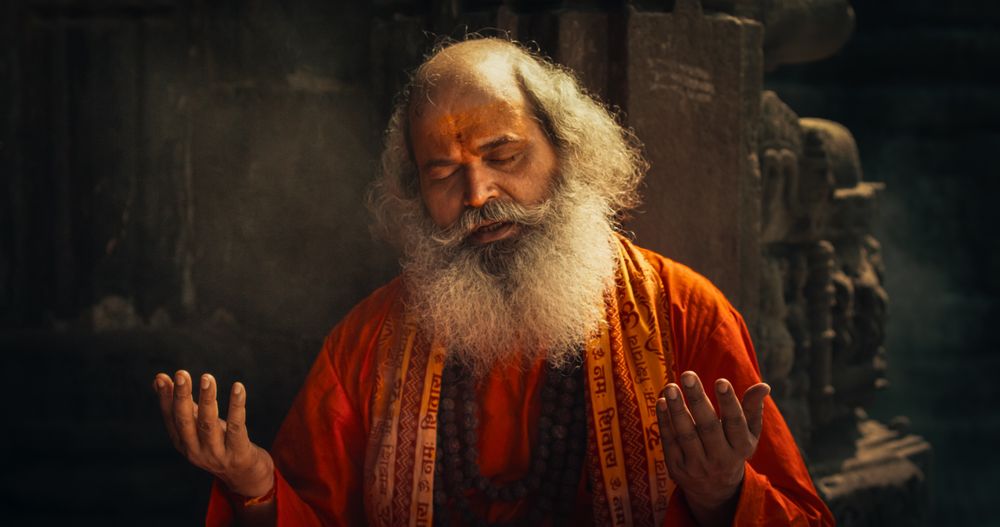 Portrait of a Hindu Monk Looking at the Camera and Smiling in an Ancient Temple.