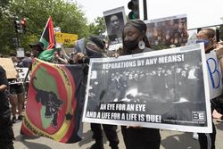 Group of protesters holding reparations, George Floyd, and Black Panther signs, Washington, D.C.