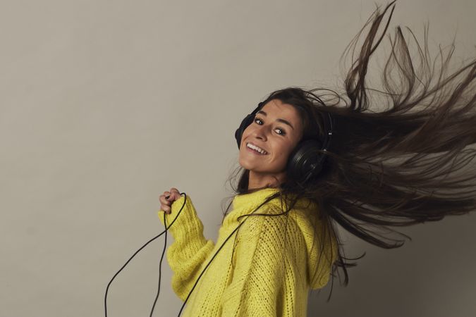 Shocked young woman listening to music in studio