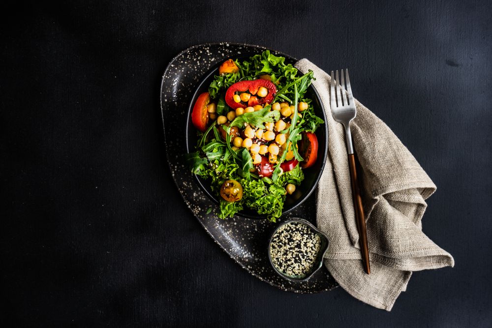 Top view of organic vegetable salad with garbanzo beans and sesame seeds