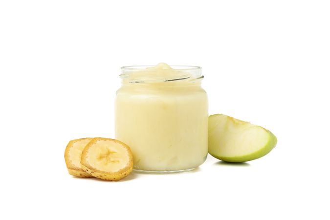 Glass jar with healthy baby food isolated on plain background