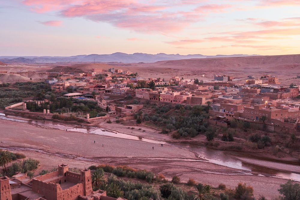 Ancient city near river in desert and wonderful sky
