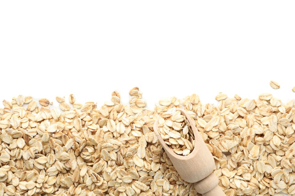 Scoop and oatmeal flakes frame isolated on plain background