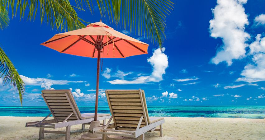 Reclining chairs overlooking a beautiful beach, wide