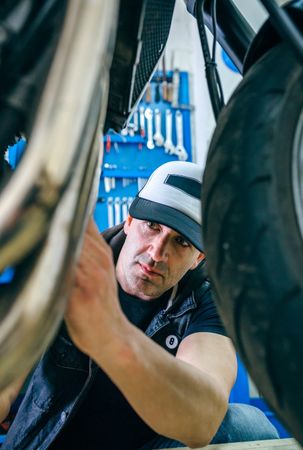 Mechanic repairing customized motorcycle