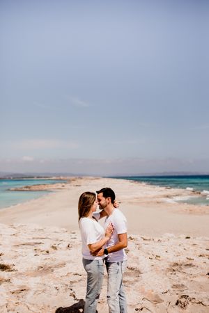 Loving couple embracing on coastline