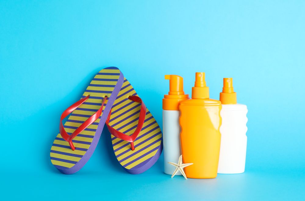 Summer vacation accessories on color background, space for text. Safe tan