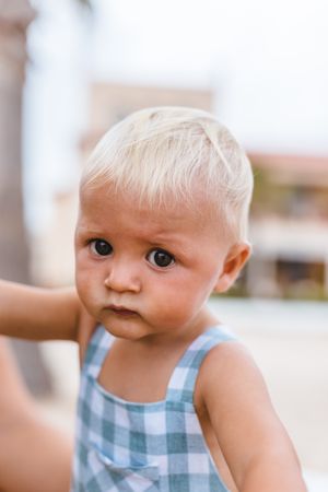 Portrait of a blonde baby boy on the beach
