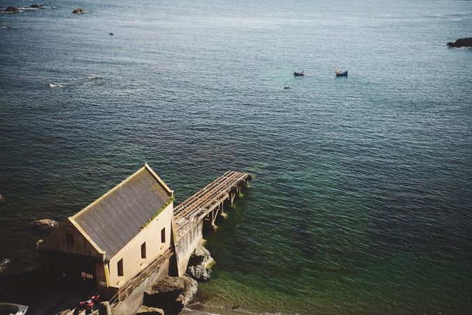 Pier with tracks going into a calm sea