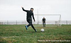 Footballer kicking a penalty shot 0JKWd5
