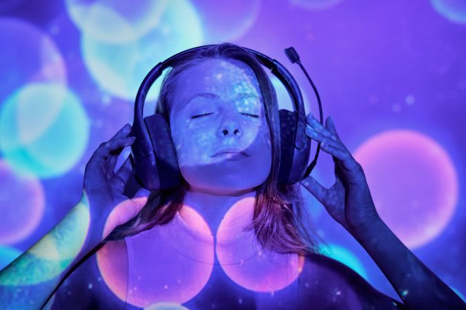 Young female listening to music with closed eyes