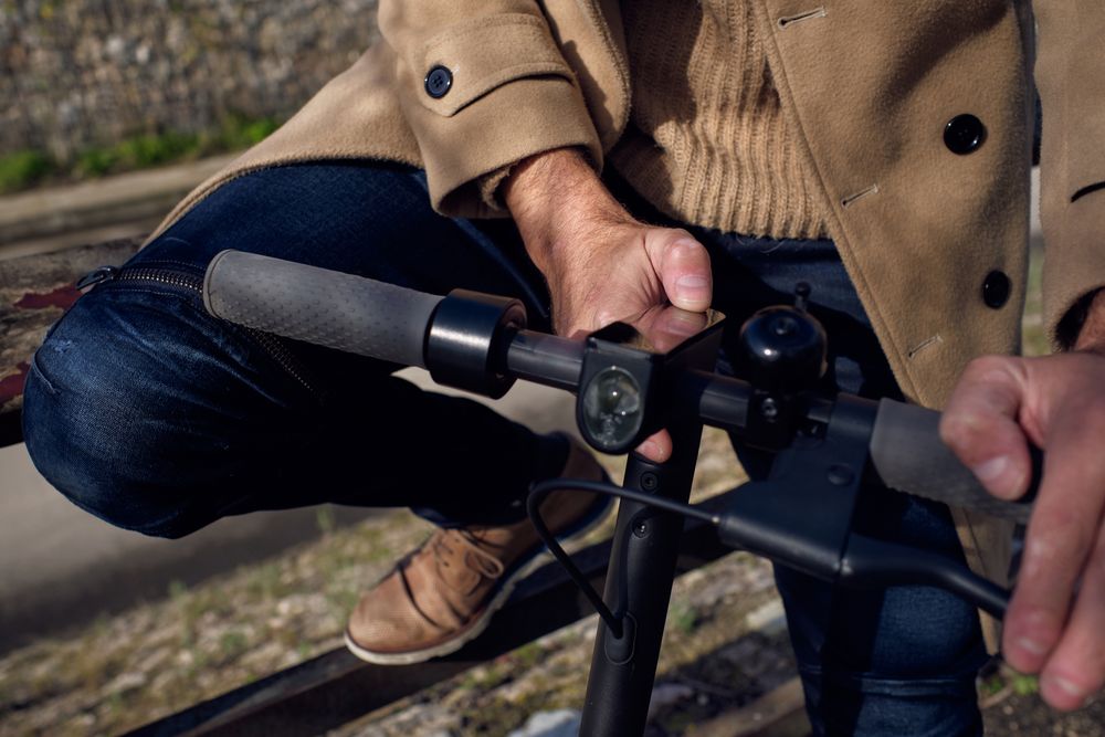 Anonymous man turning on scooter