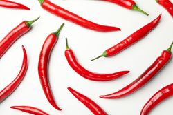 Flat lay with chilli peppers on blank background, top view