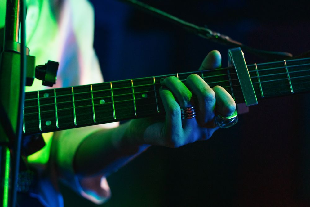 Musicians In Stage With Colorful Lights Performing In A Live Concert