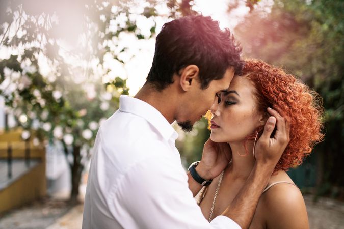 Close up of a young couple intimately close touching with heads about to kiss