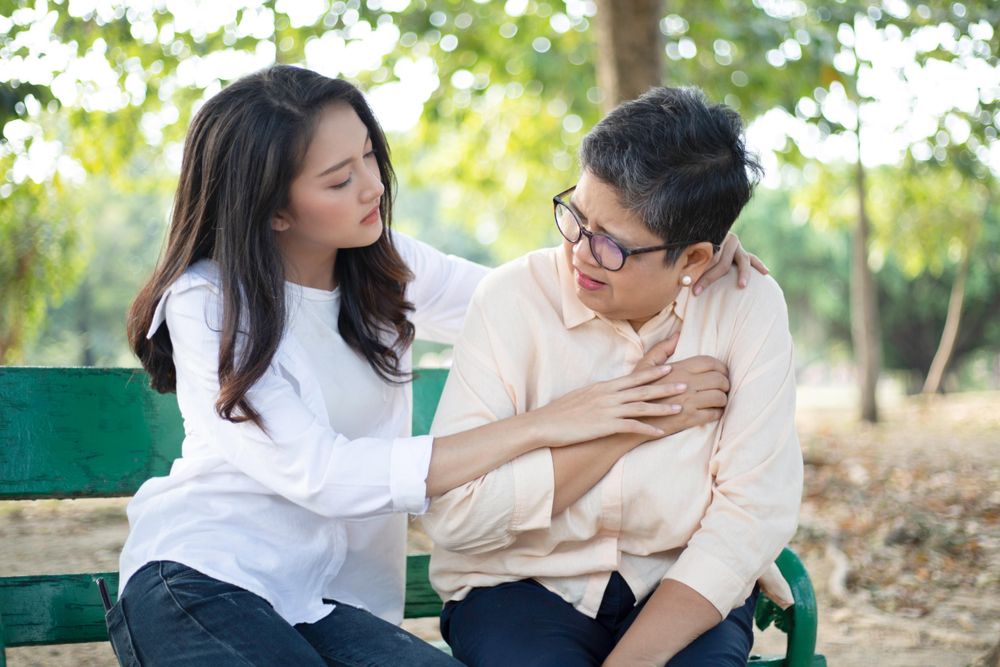 Daughter caring for older mother having chest pain
