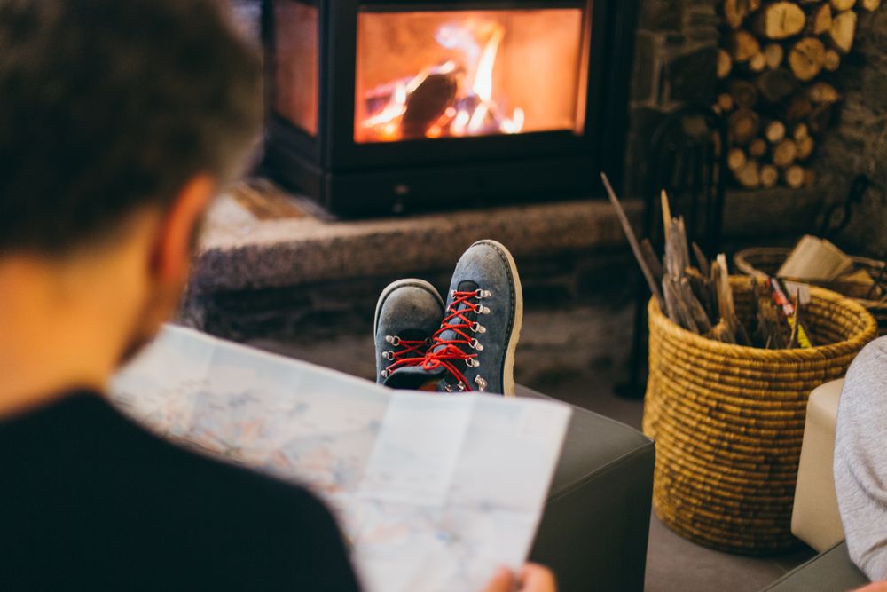 Man reading by the fireplace